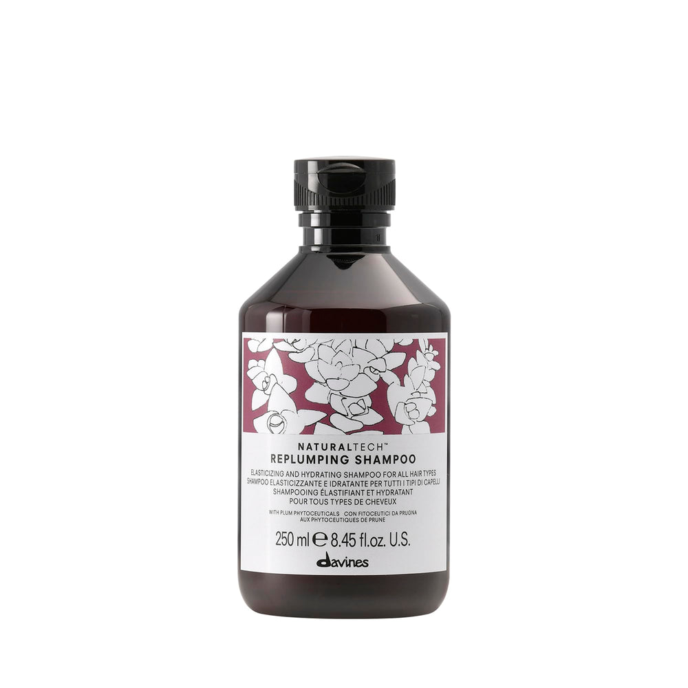 Davines Replumping Shampoo bottle-front with rich foam signaling elasticity