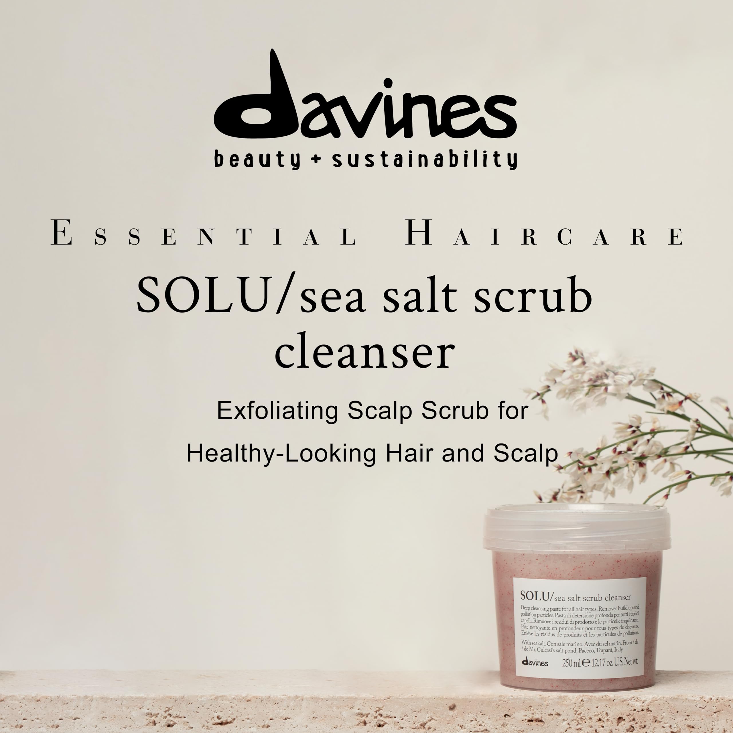 Davines SOLU sea salt scrub on wet hair, showing gentle scalp refreshment.
