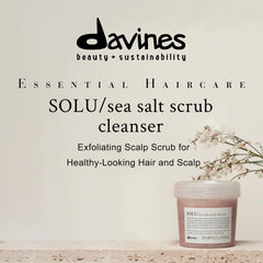 Davines SOLU sea salt scrub on wet hair, showing gentle scalp refreshment.