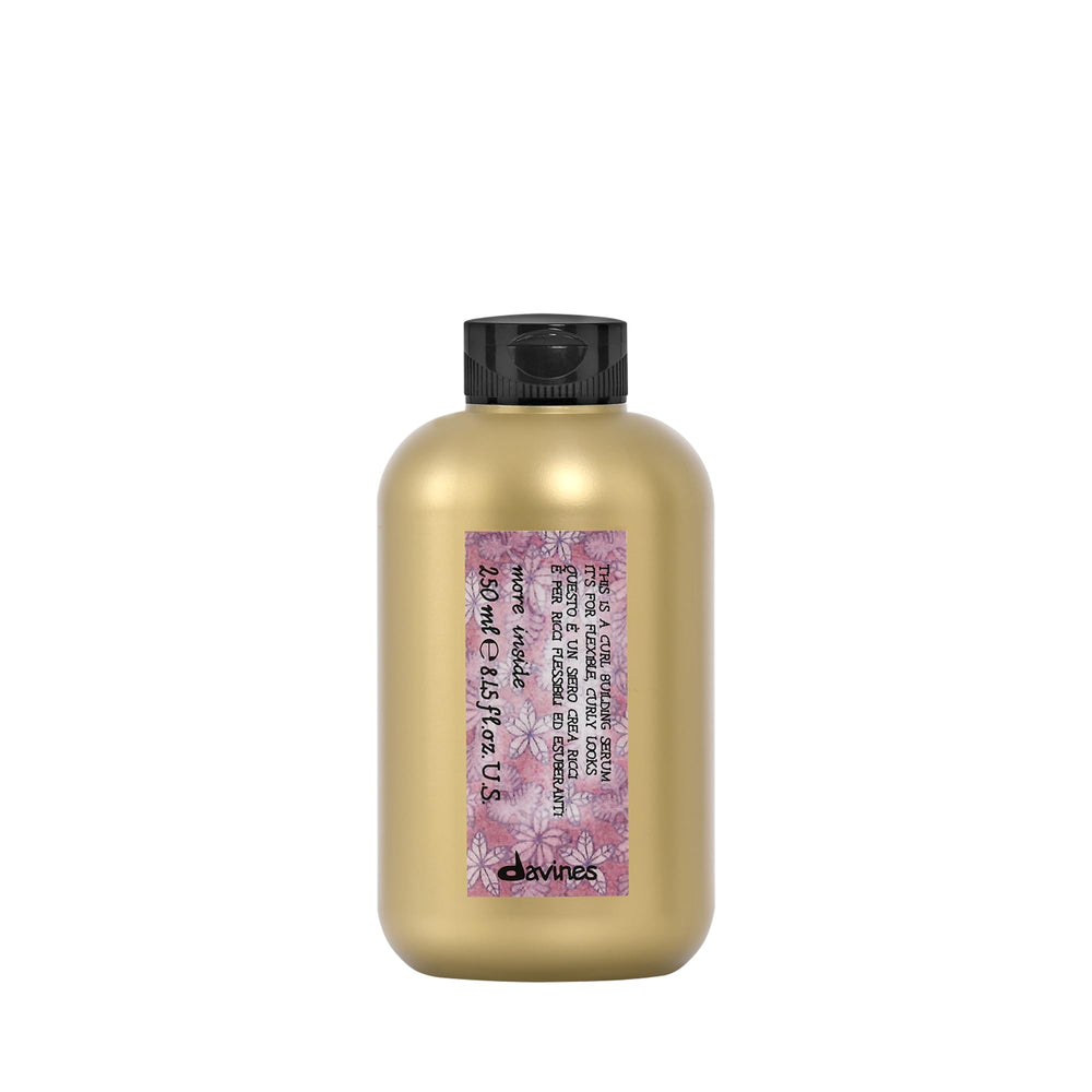 Davines This Is A Curl-Building Serum bottle showing defined curls