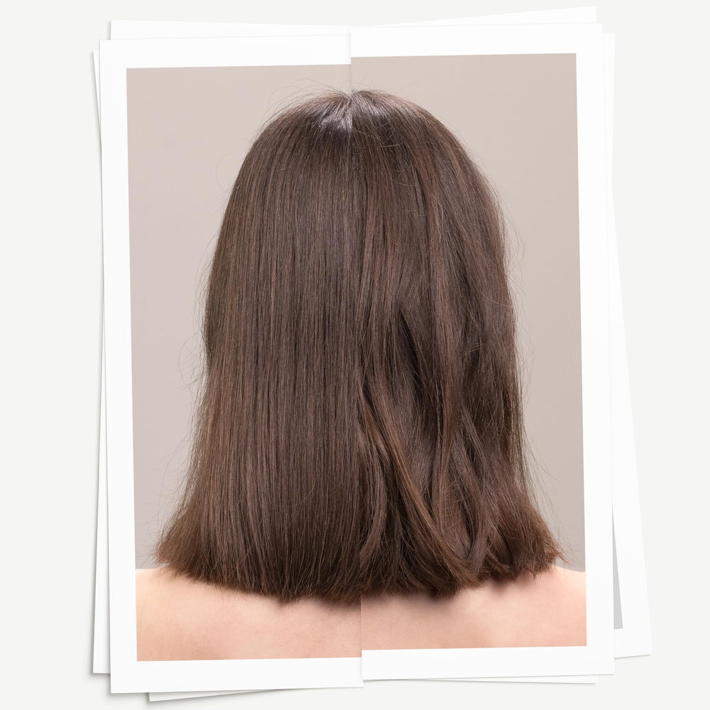 Hands applying Davines sea salt spray to create casual, textured waves.