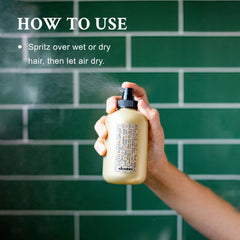 Damp hair ready to air-dry with Davines sea salt spray for volume.