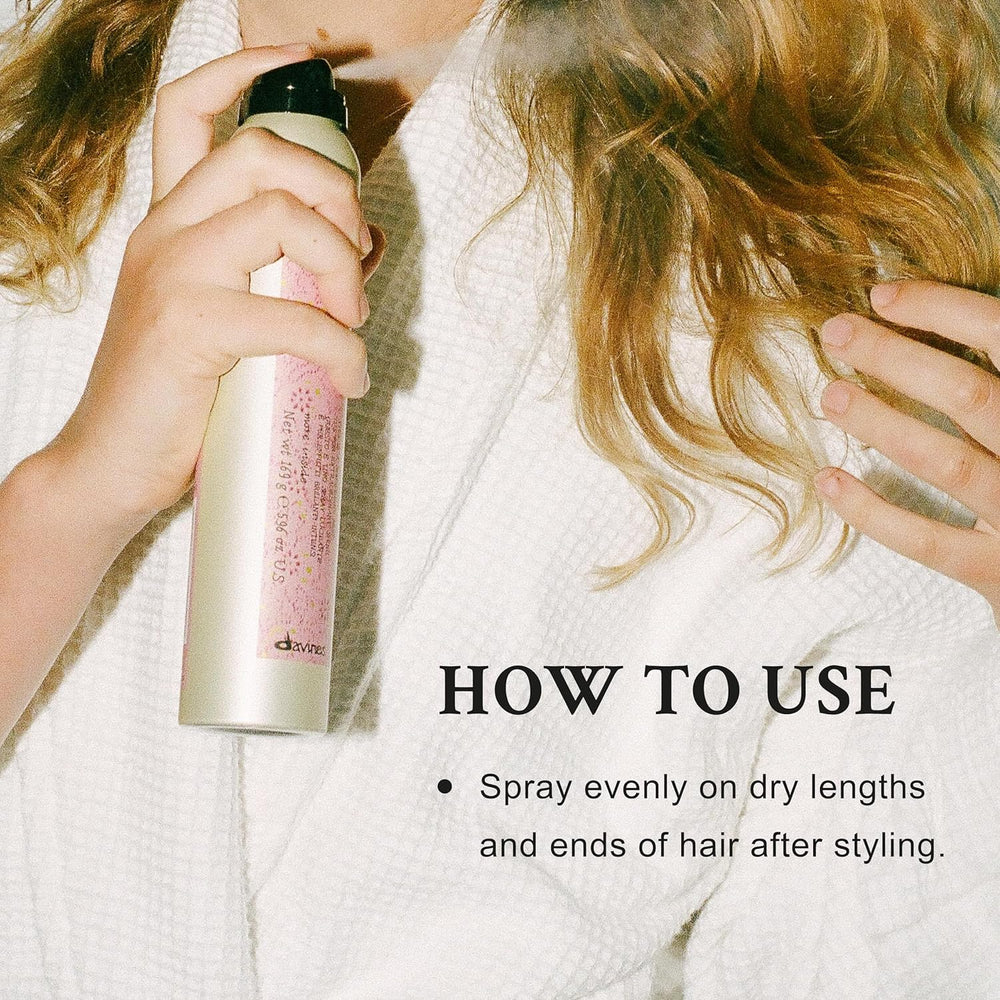 Davines This Is A Shimmering Mist being sprayed on damp hair for weightless shine.