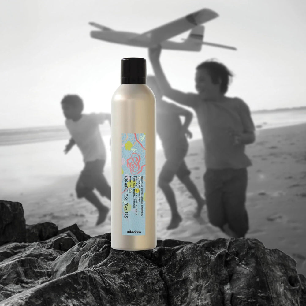 Davines This Is An Extra Strong Hair Spray spray action showing mist for strong hold.