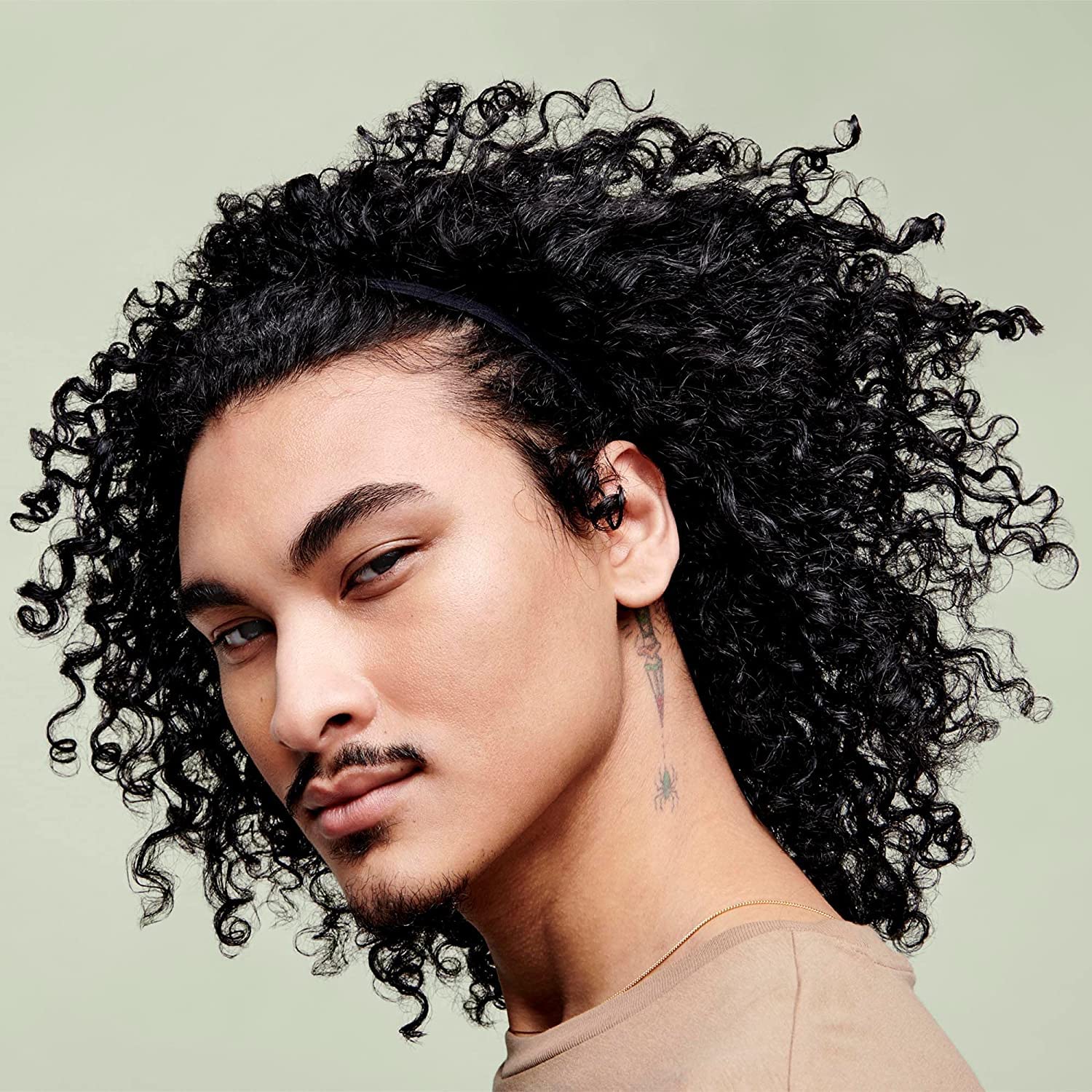 DevaCurl Leave-In Decadence Green Oasis defined curls with added shine.
