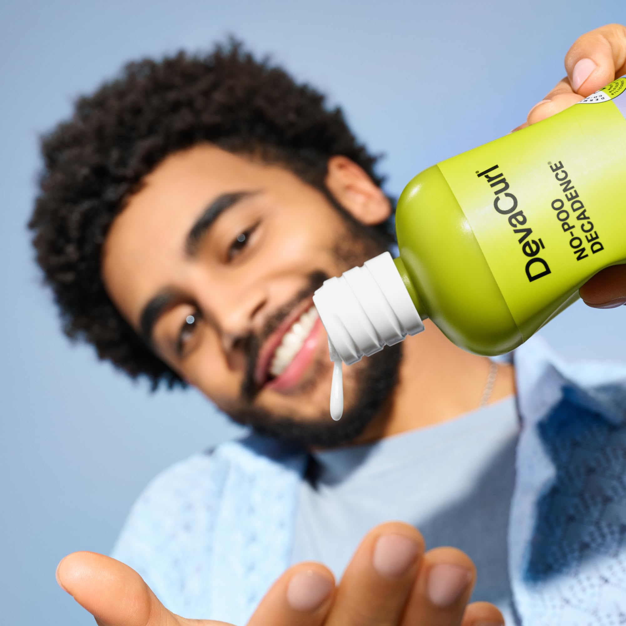 Hair model with relaxed curls after cleansing, demonstrating improved manageability.