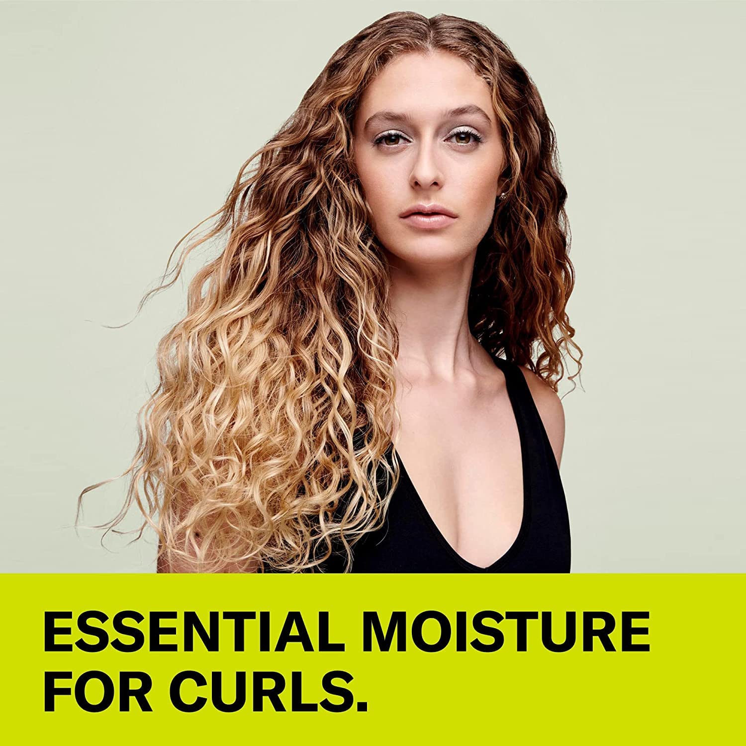 Applying DevaCurl No-Poo Original to damp hair for gentle cleansing.