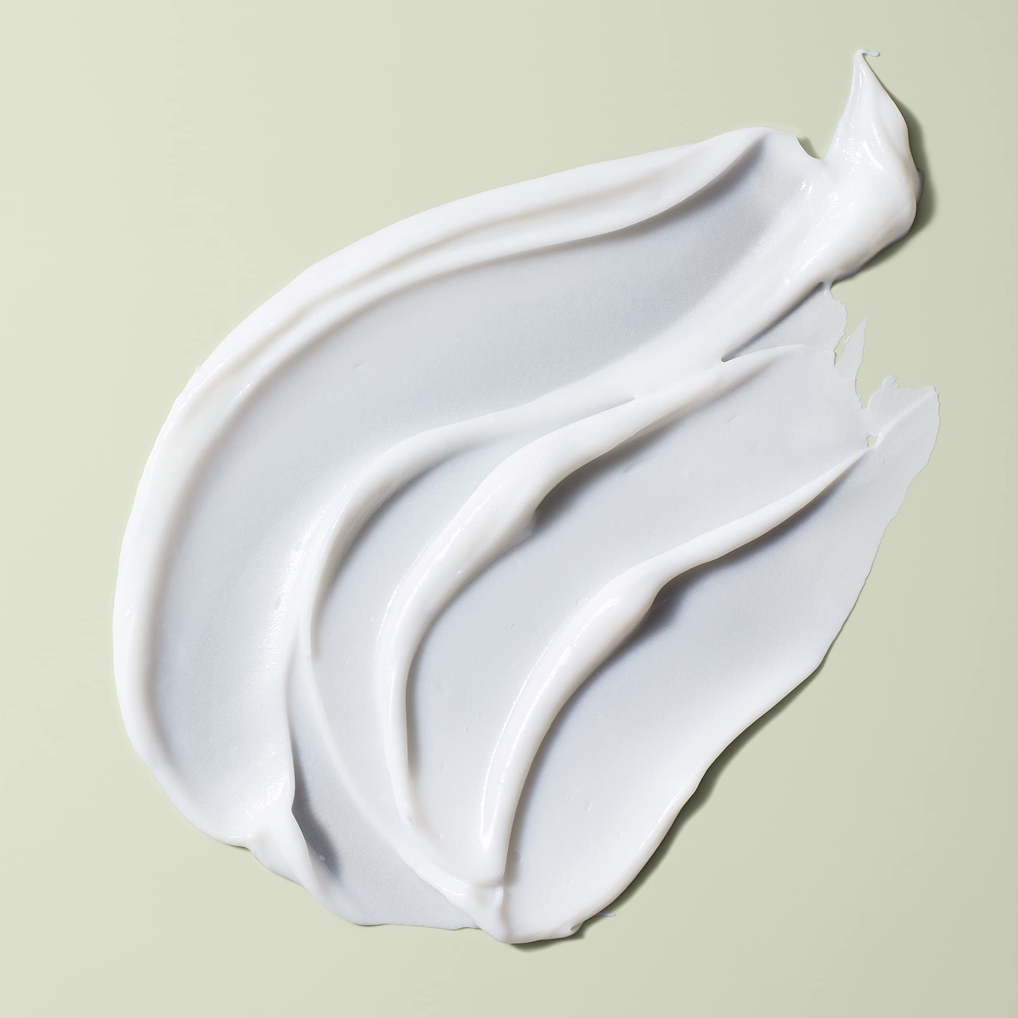 DevaCurl Decadence conditioner being applied for detangling and frizz control.