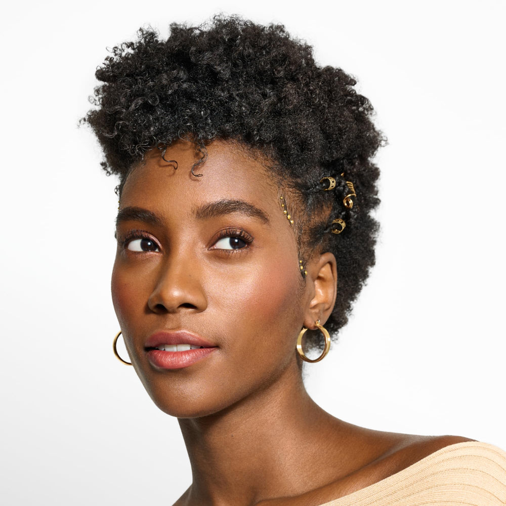 Close-up of curling hair defined with DevaCurl Decadence conditioner.
