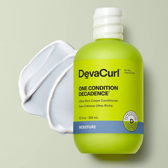 Close-up of Green Oasis bottle pouring hydration onto curly hair.