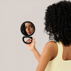 Diane Hand Mirror foldable stand for hands-free grooming.