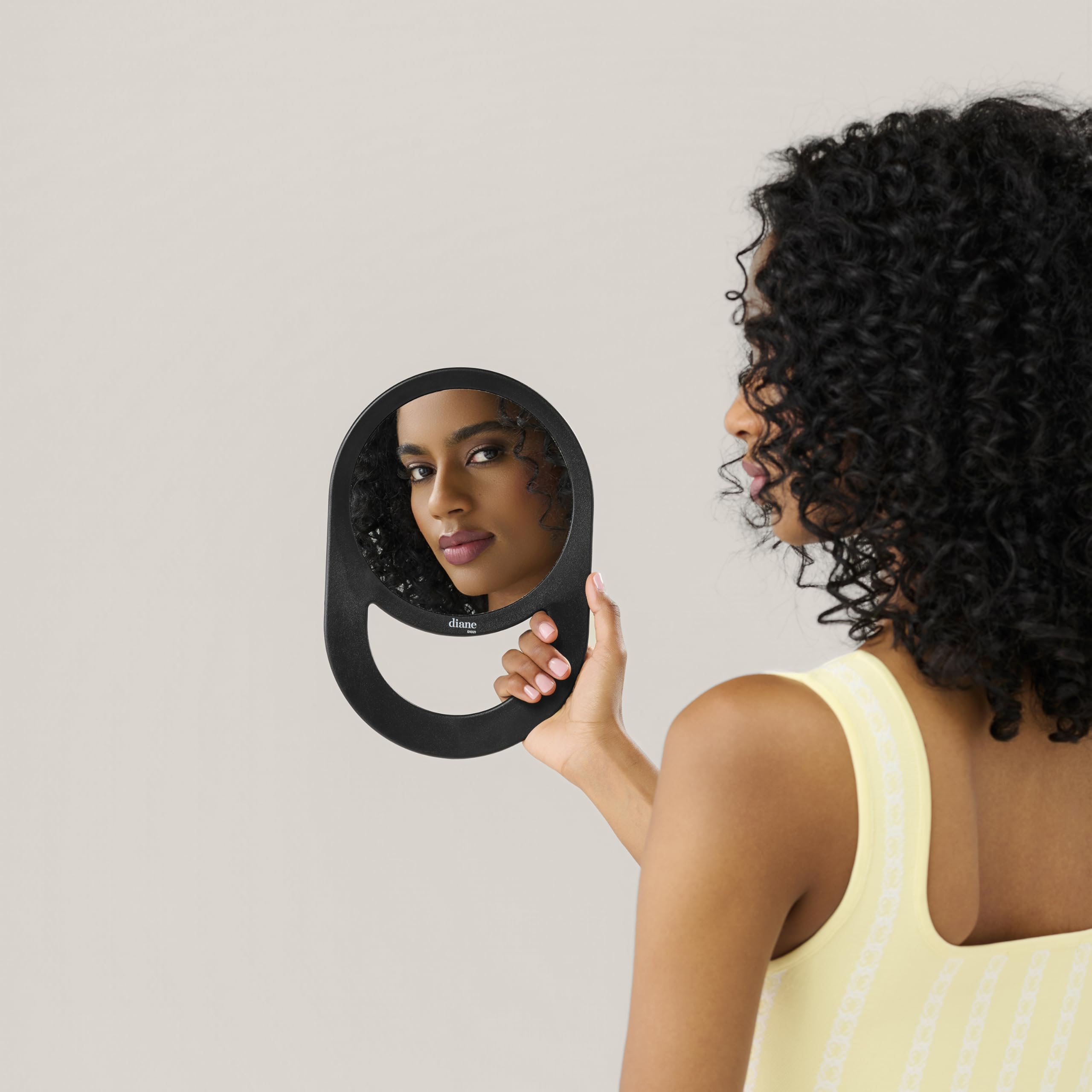 Diane hand mirror with hold-and-hang design offers flexible use at home or in the salon.