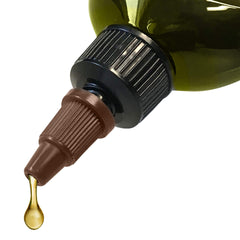 Difeel peppermint hair oil bottle pour action shows easy root and strand application.