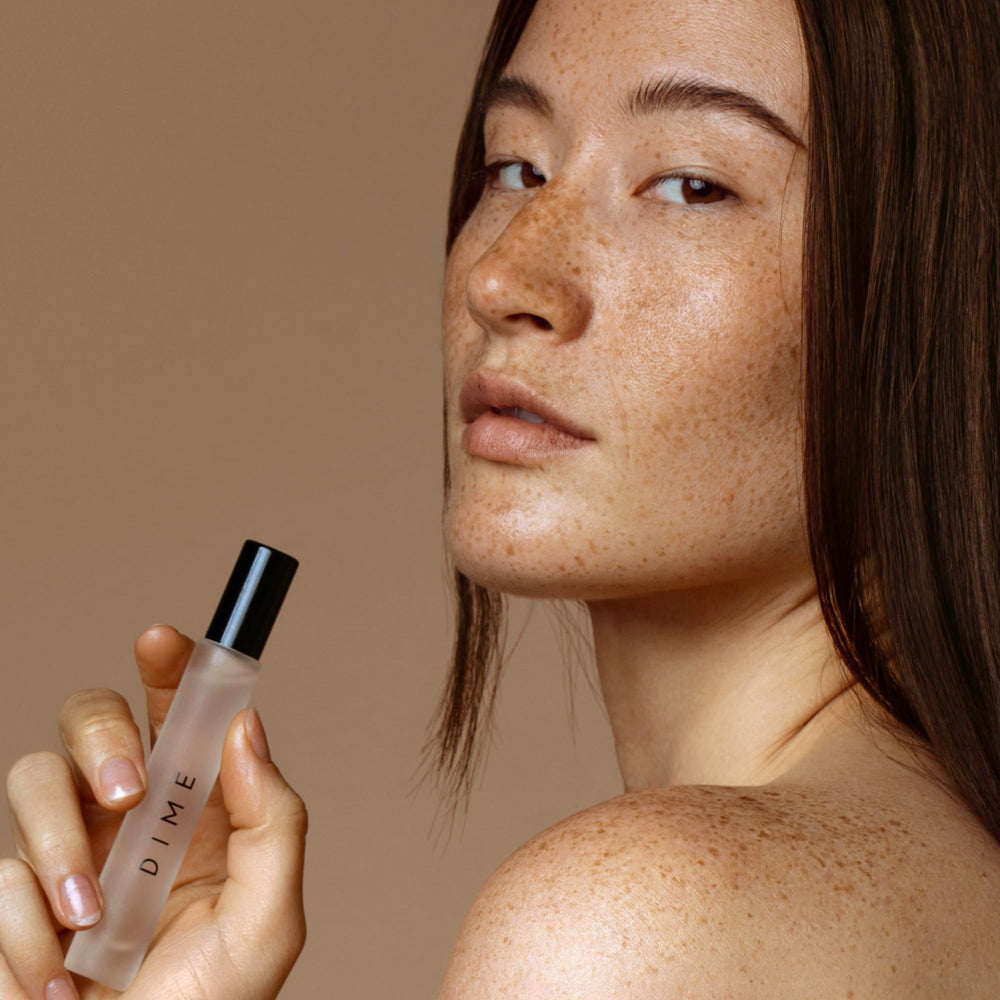DIME Dans Les Bois travel spray; compact luxury for on-the-go fragrance.
