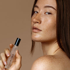 DIME Dans Les Bois travel spray; compact luxury for on-the-go fragrance.