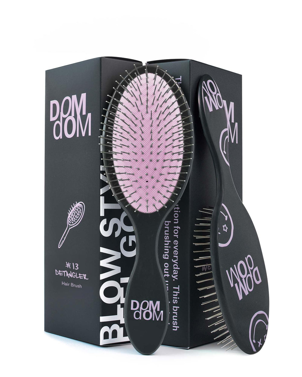Dom Dom detangling brush with drainage hole for fast drying after shower.
