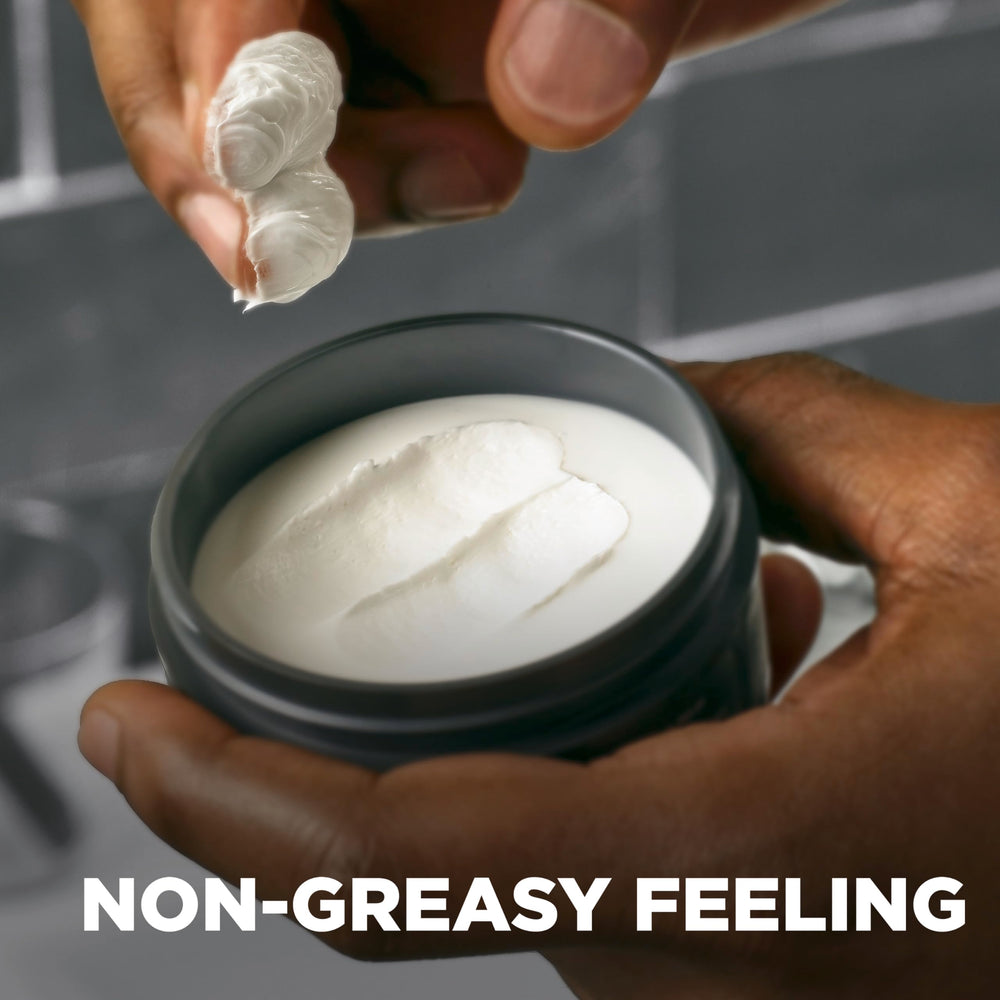Dove Men+Care Sculpting Paste applied through hair for a natural textured look.