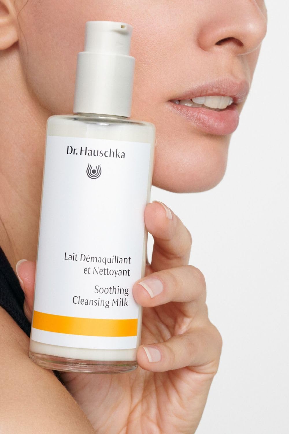 Applying cleansing milk as makeup remover for a clean, refreshed complexion.