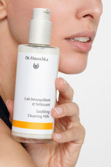 Applying cleansing milk as makeup remover for a clean, refreshed complexion.