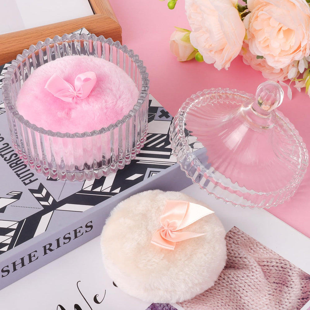 Draupnir large dusting puff in use for body powder.
