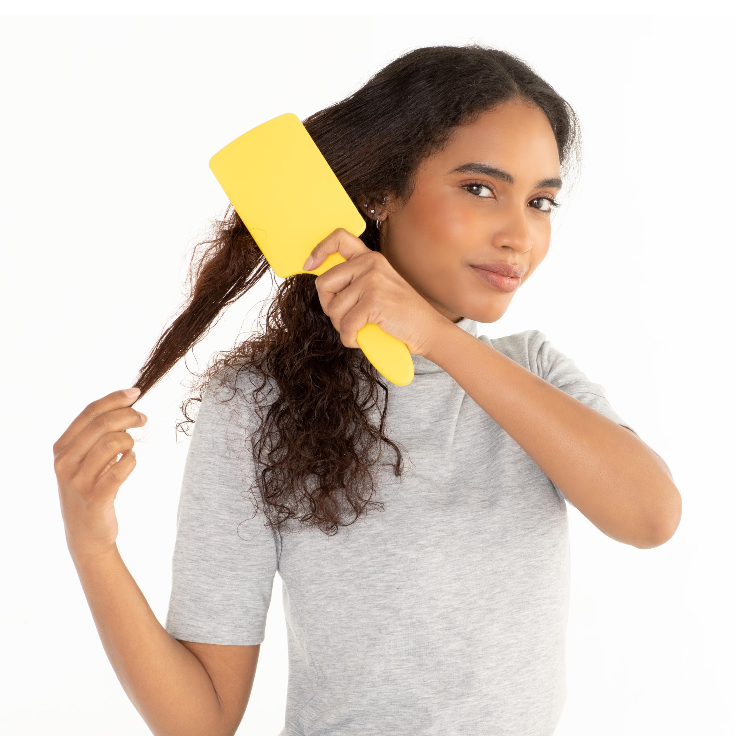 Drybar Lemon Bar Paddle Brush on dry hair supports a smooth blowout.