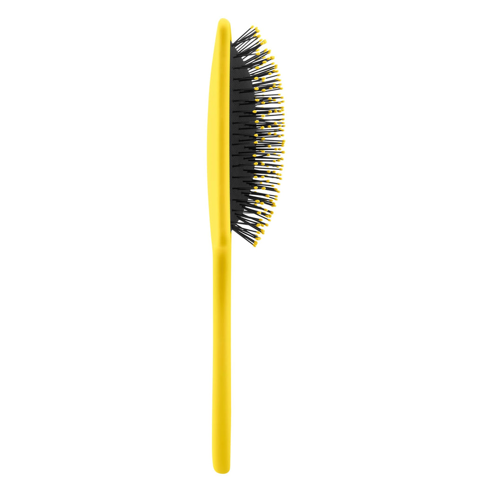 Drybar Lemon Bar Paddle Brush on wet hair detangles without pulling.