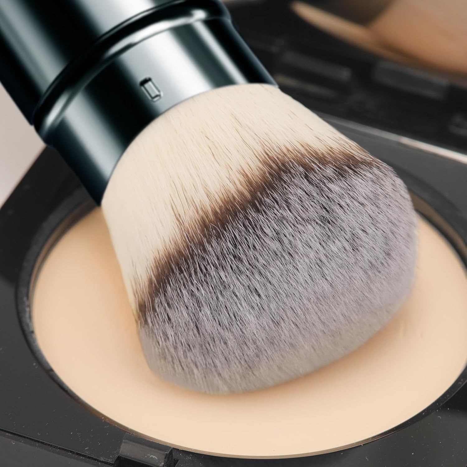 DUcare powder and bronzer blending for a natural finish with kabuki brush.
