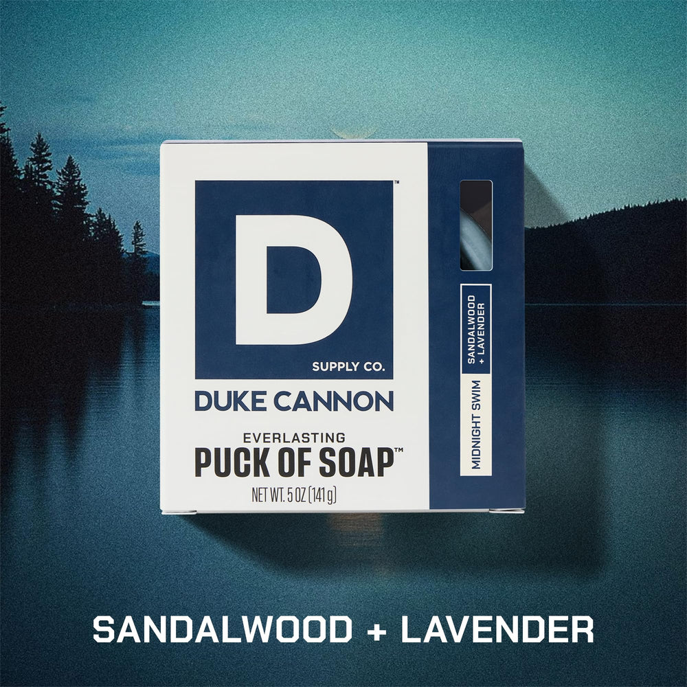 Duke Cannon bar soap puck in hand highlights round design for grip.