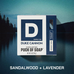 Duke Cannon bar soap puck in hand highlights round design for grip.