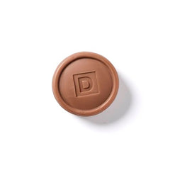 Round design of Duke Cannon Bar Soap Puck emphasizes comfortable shower grip.
