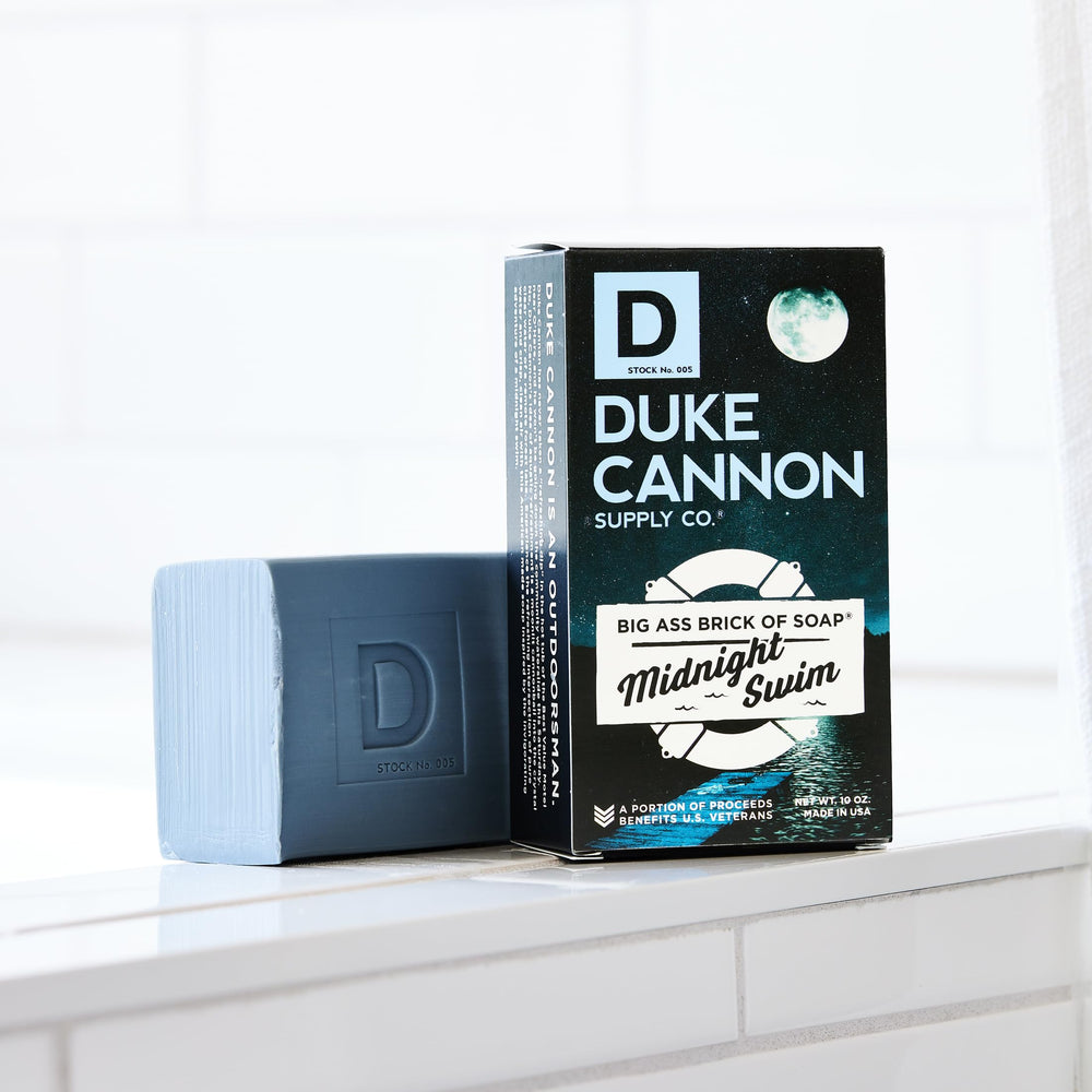 Angled shot of Duke Cannon Midnight Swim soap bar suggesting durable, long-lasting use.