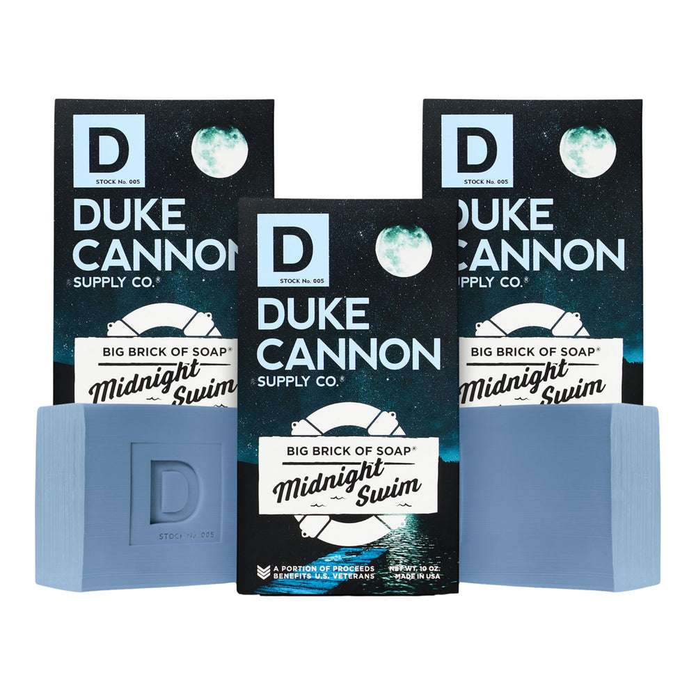 Duke Cannon Midnight Swim soap bar close-up showing a rich lather for daily cleansing.