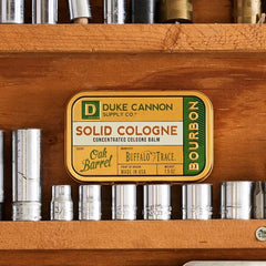 Duke Cannon solid cologne bourbon texture close-up, long-lasting fragrance on skin.