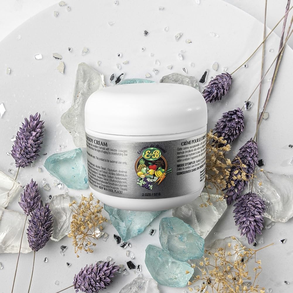 Close-up of E de B Essence cream being applied to skin for nourishment.