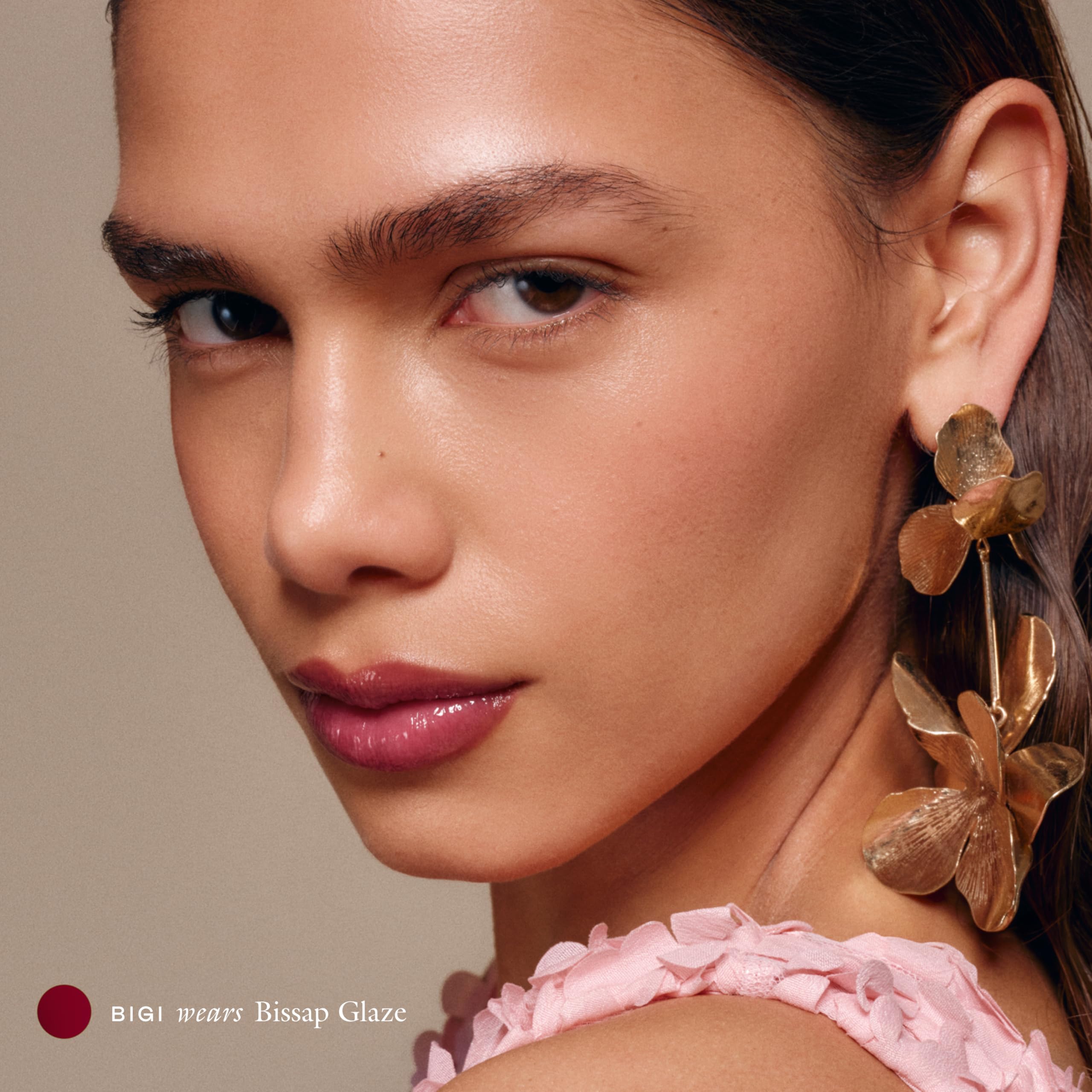 EADEM Le Chouchou lip gloss close-up reveals rich plum shine.