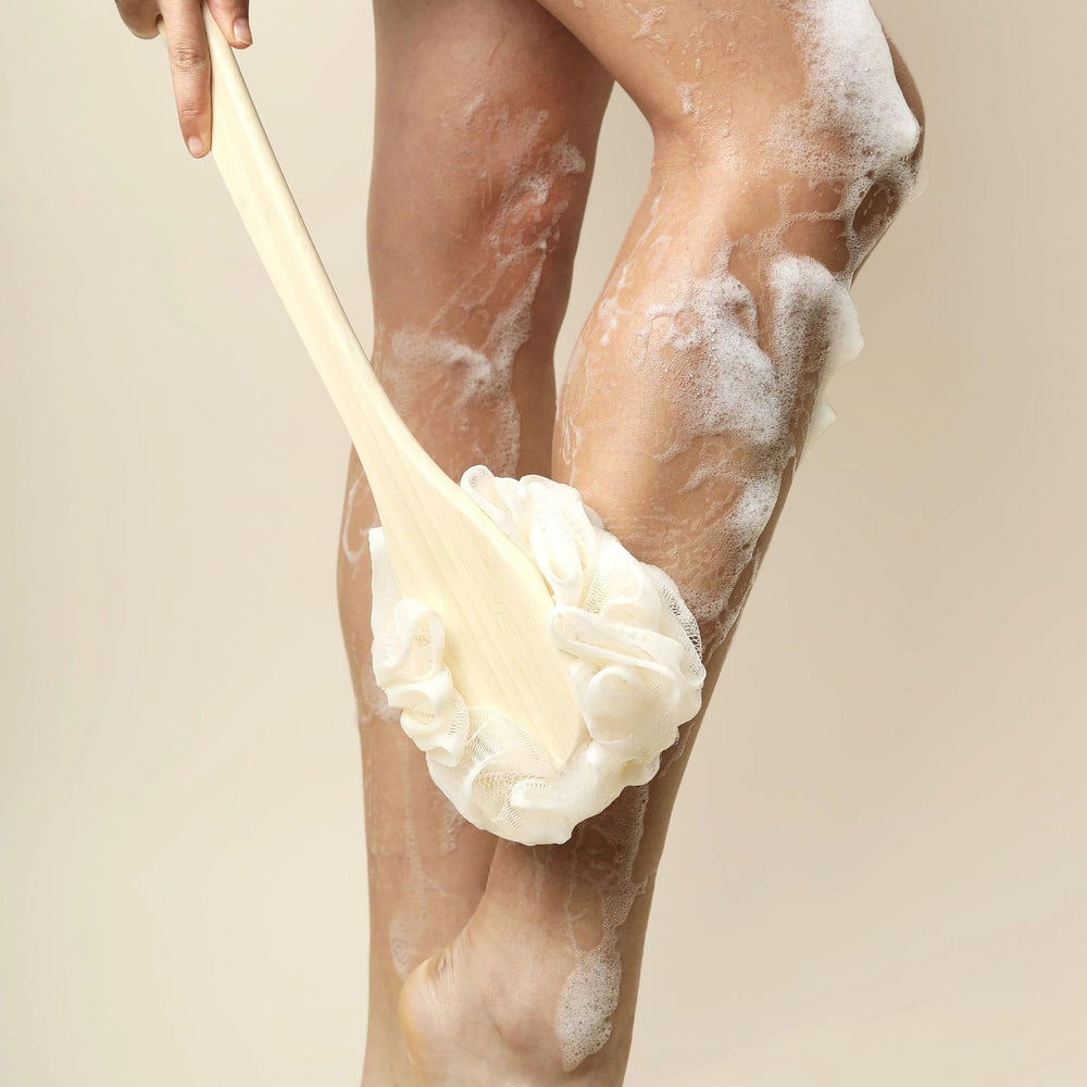 Back-access demonstration with EcoTools EcoPouf Bath Brush