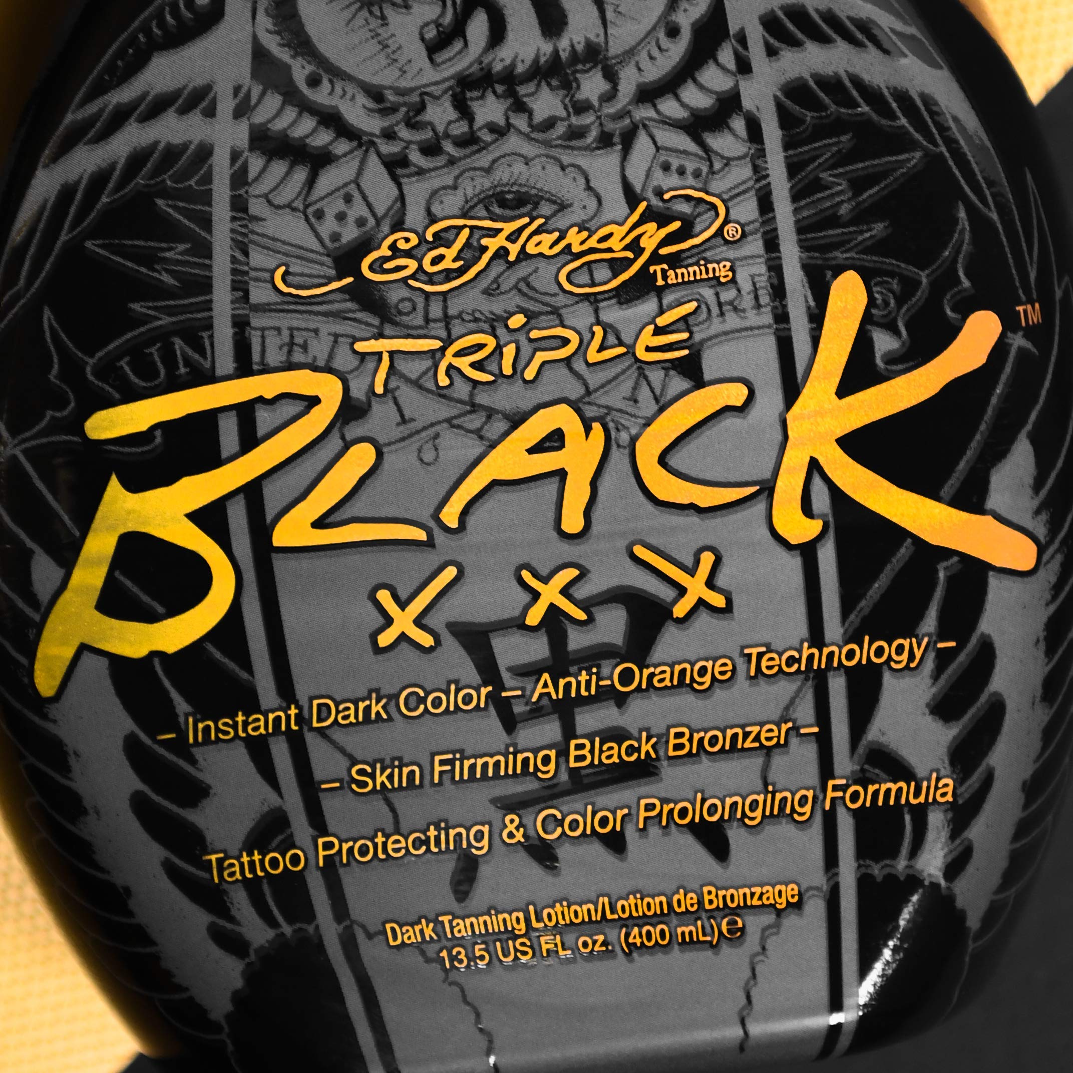 Blue Tansy protects tattoo color during tanning with Ed Hardy Black XXX.