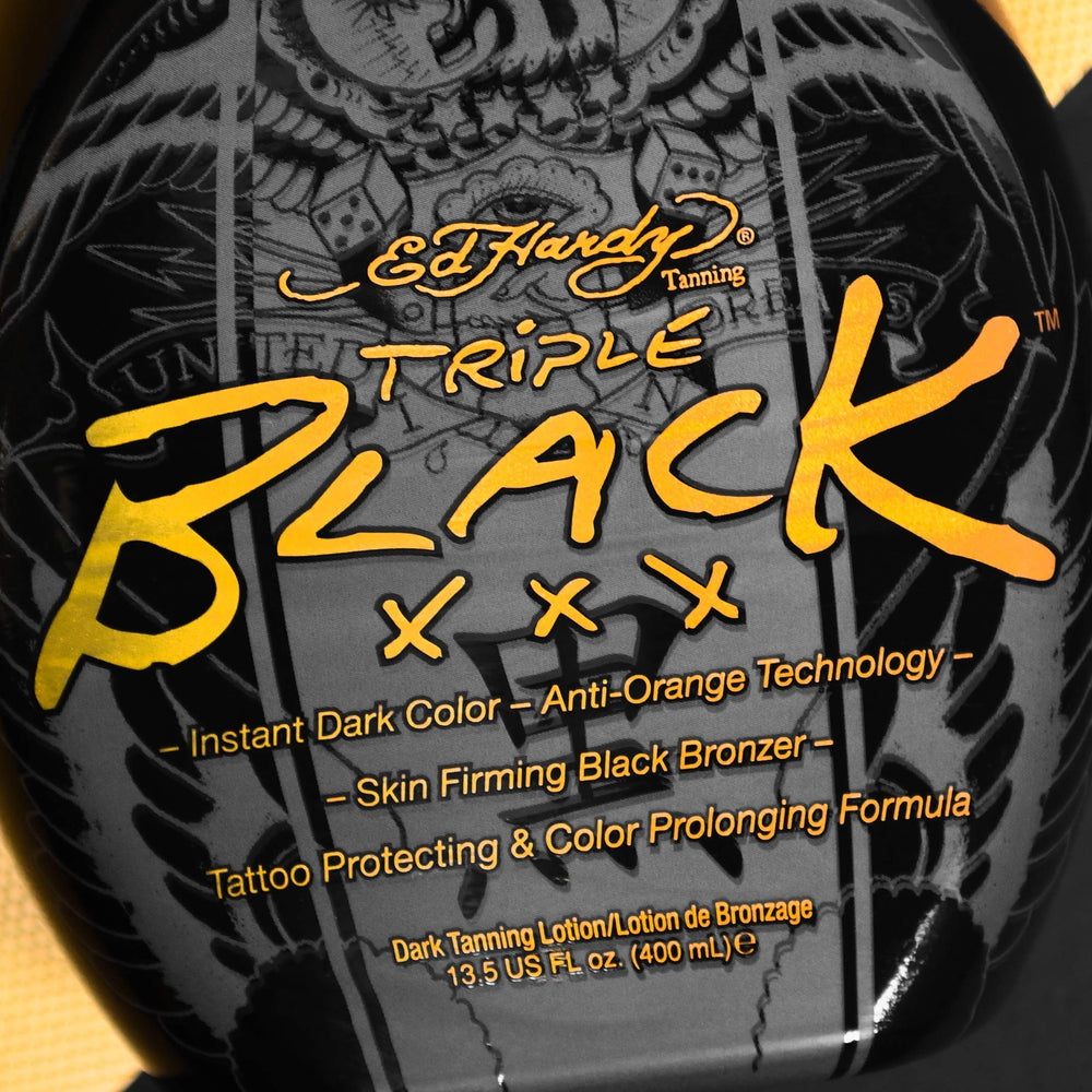 Blue Tansy protects tattoo color during tanning with Ed Hardy Black XXX.
