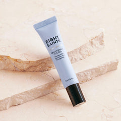 Close-up of the cooling applicator gliding over the under-eye area to reduce puffiness.