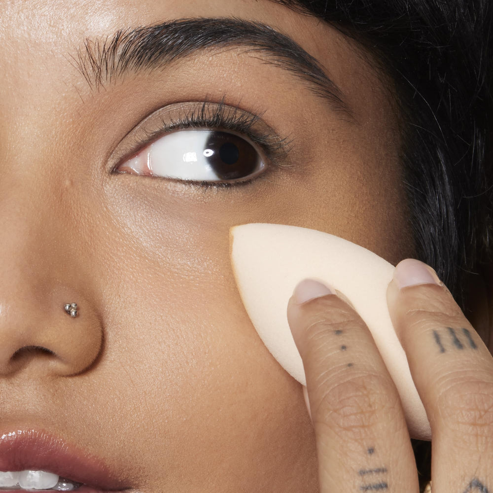 e.l.f. Camo Concealer Sponge damp for even, seamless coverage.