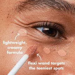 e.l.f. Soft Glam Brightening Corrector wand demonstrates precise application with flexible tip.