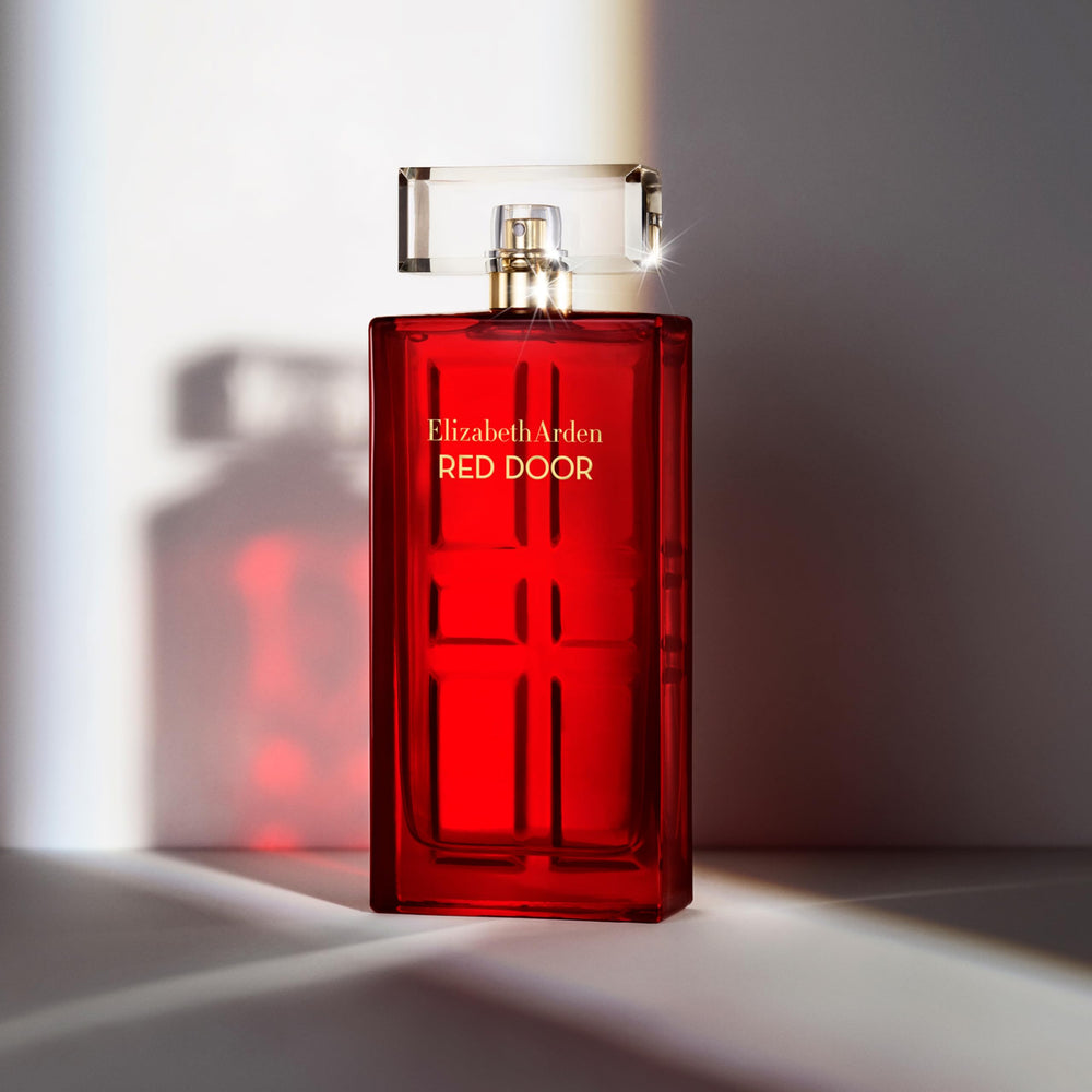 Elizabeth Arden Red Door bottle on a vanity with soft lighting.