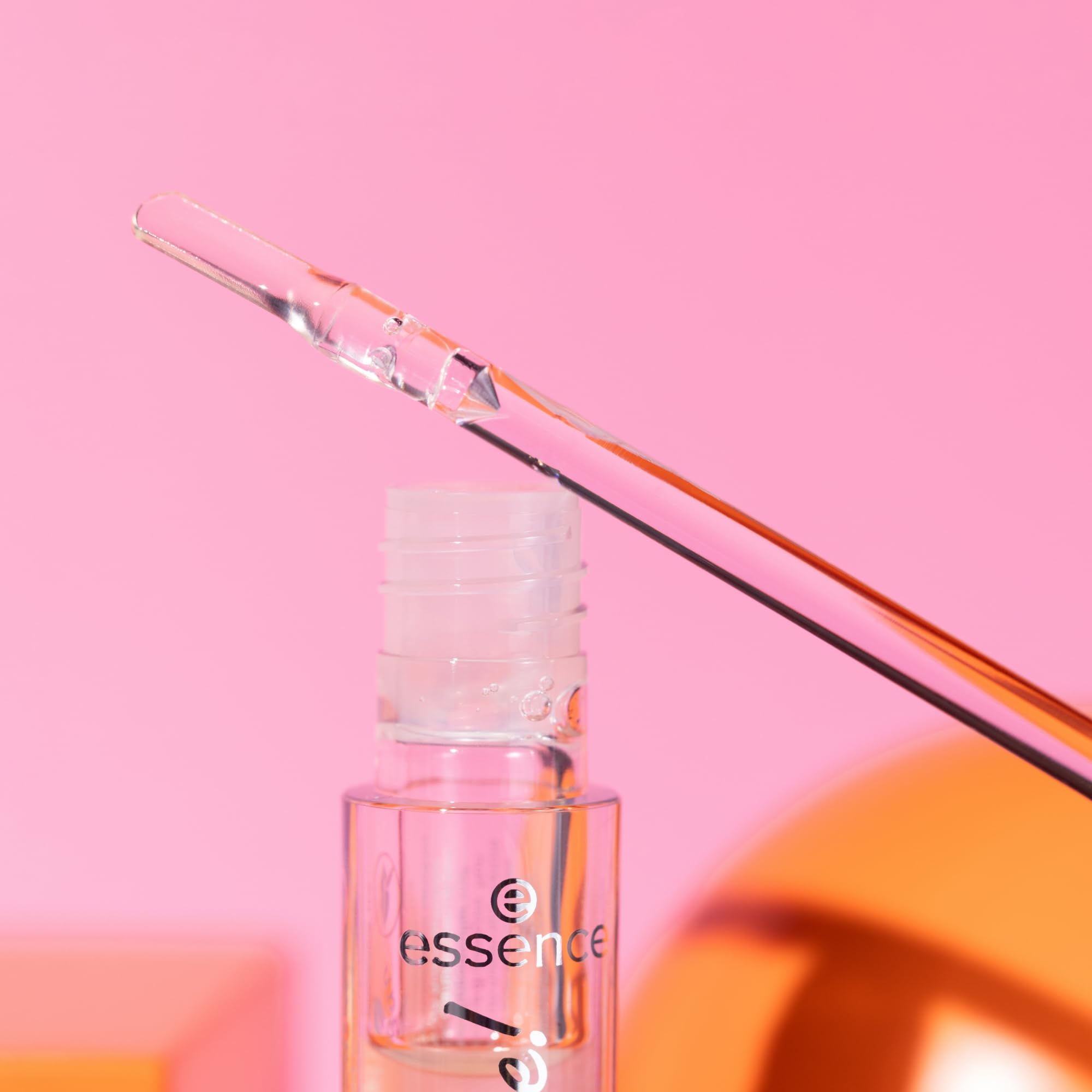 essence bold glass finish close-up demonstrates luminous, statement lip look.