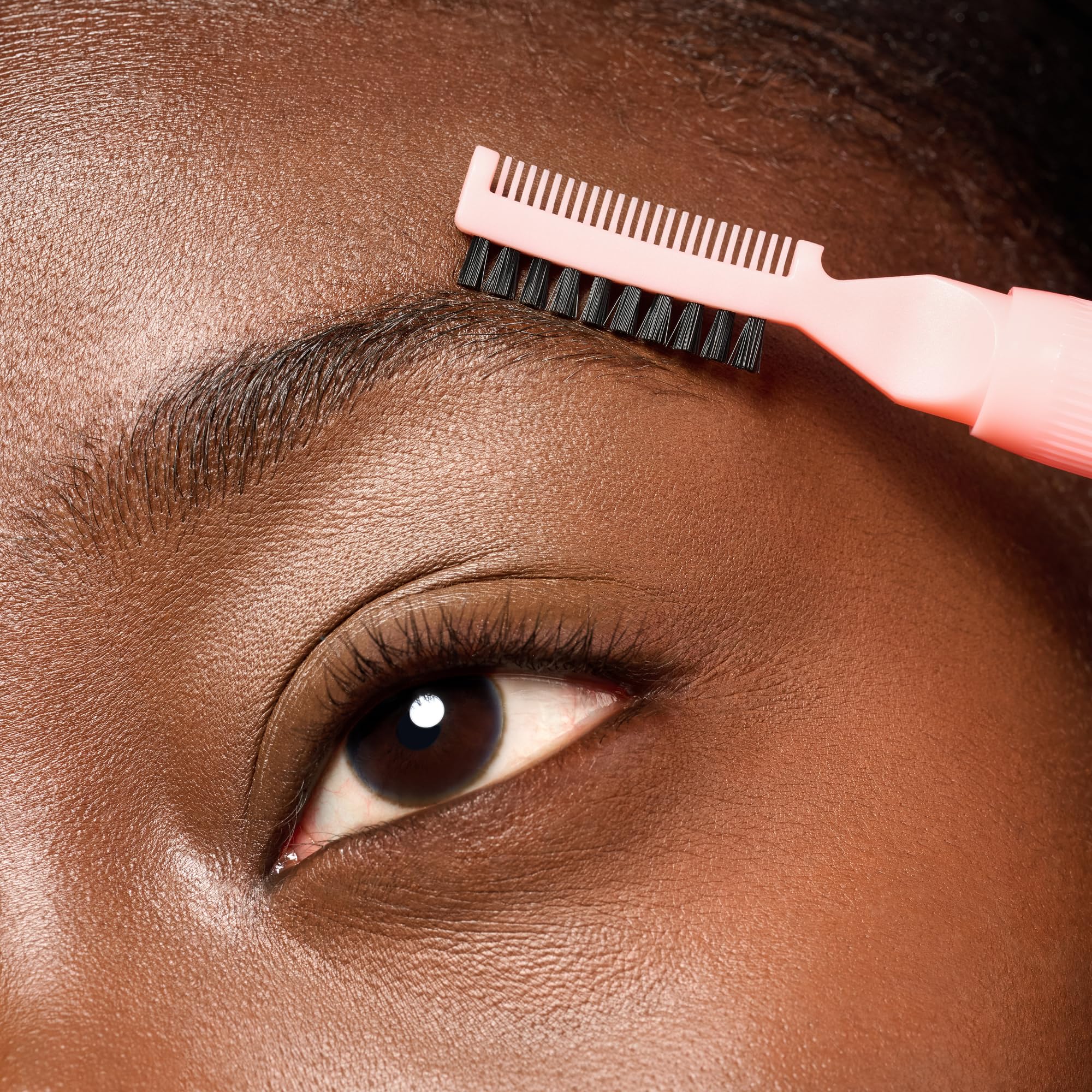 essence brow lift & freeze glue applied with upward strokes.