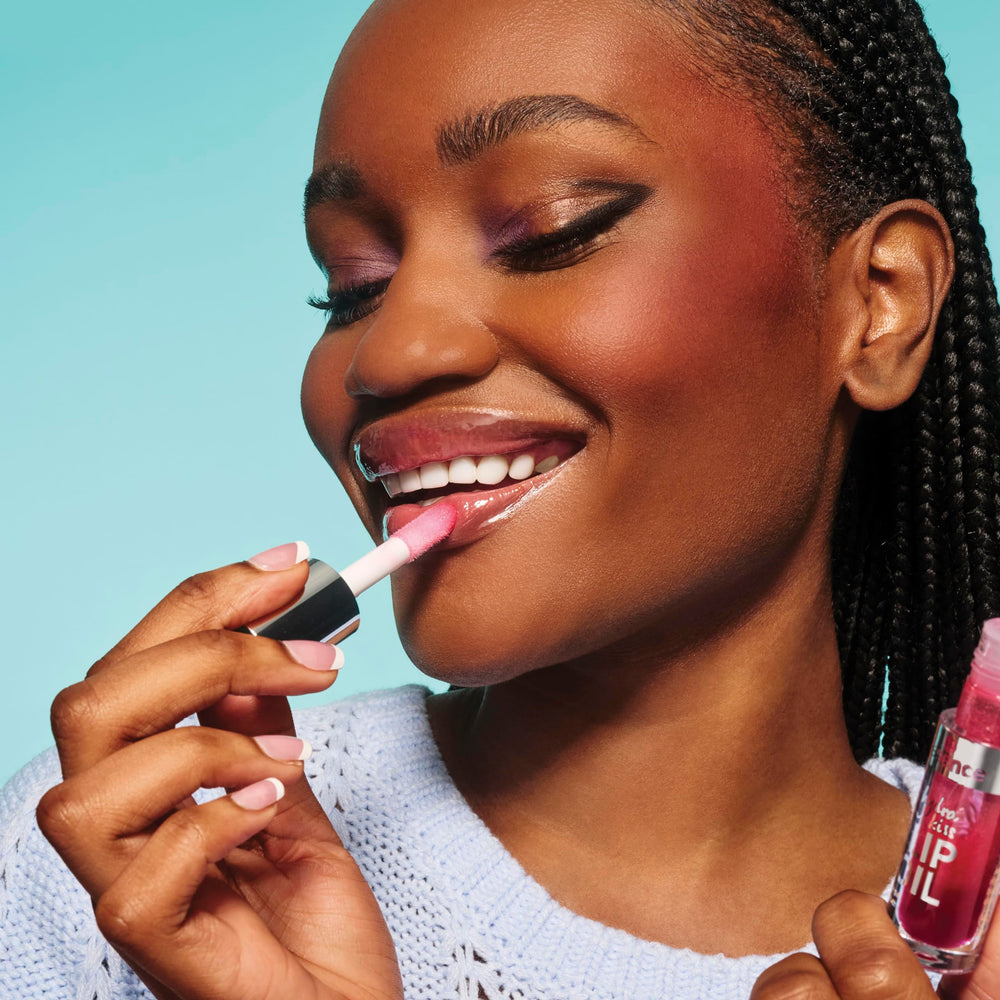 essence Hydra Kiss Lip Oil being applied for a glassy lip look.