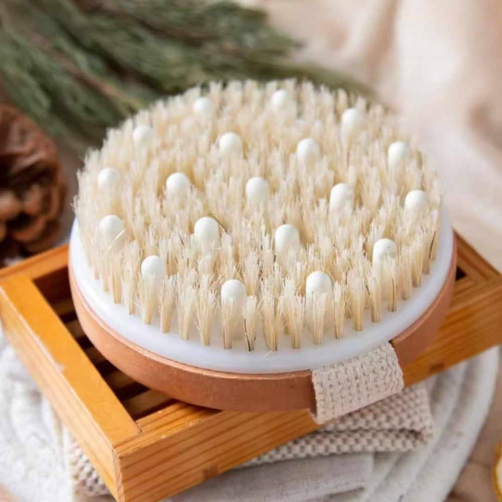 Essential Aura dry body brush used in spa-like rituals with oils for relaxation.