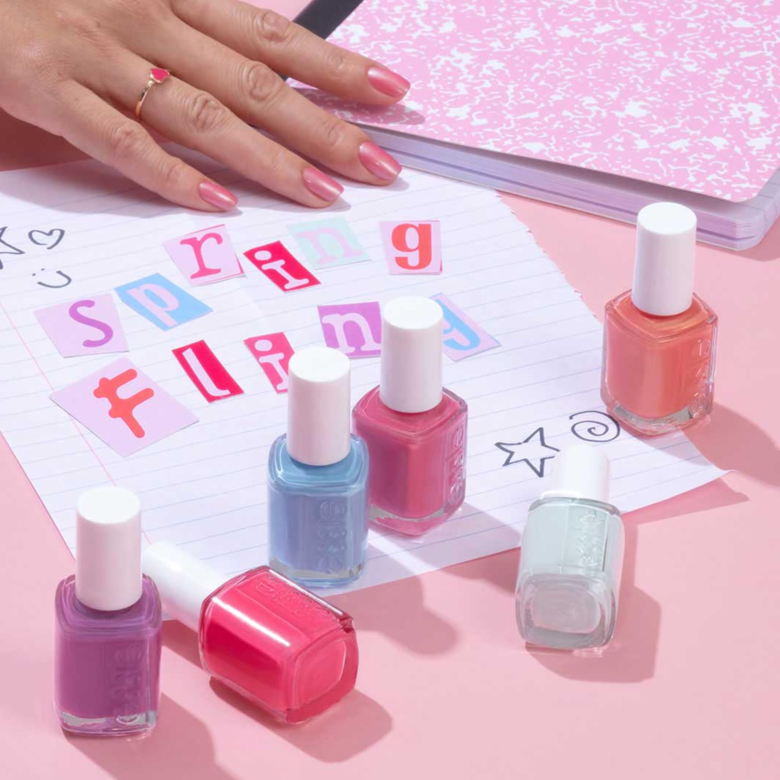essie blue cream polish on fingernail during application for rich color.