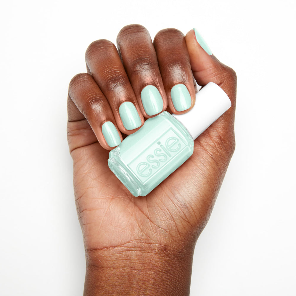 essie Seas The Day on sun-kissed nails during a summer beach day