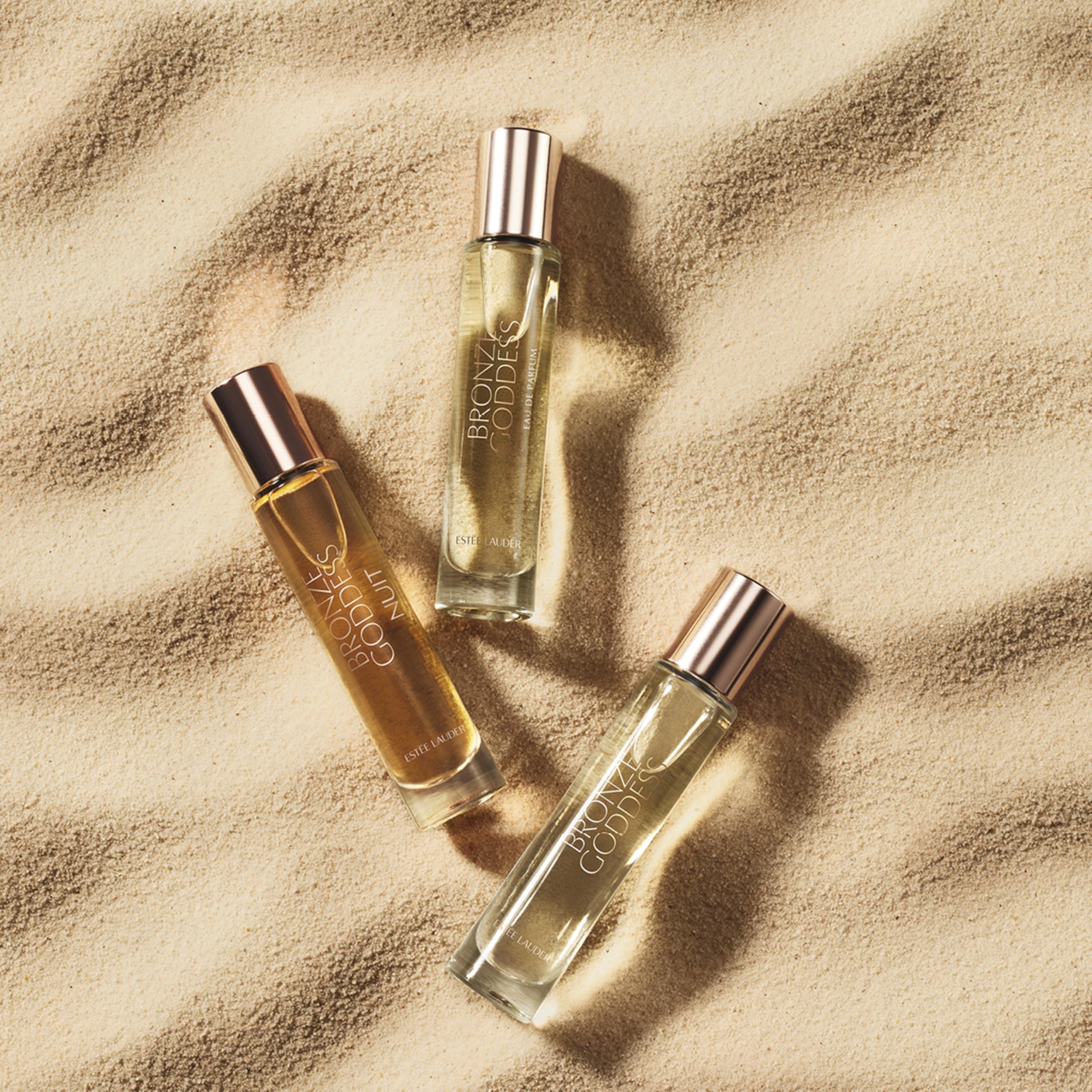 Estee Lauder Bronze Goddess Nuit bottle pour demonstrates easy, on-the-go use