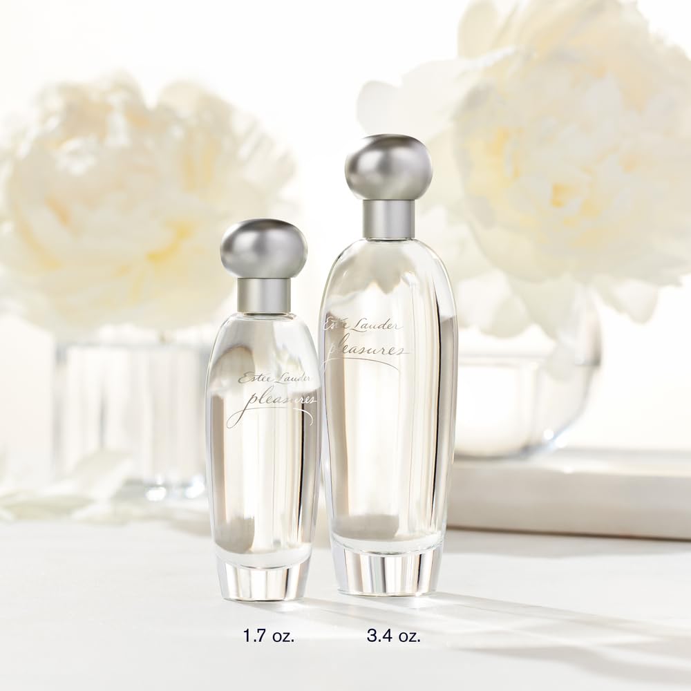 Estée Lauder Pleasures bottle with white peonies, airy and luminous mood.